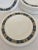 A delicious set of 12 Wedgwood dinner service plates having black and gold border with fabulous Greek key motife.