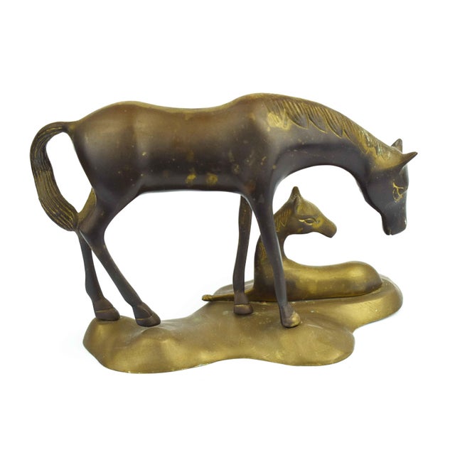 Capture the tender bond of nature with this vintage-style brass sculpture featuring a mare and her resting foal. Crafted...