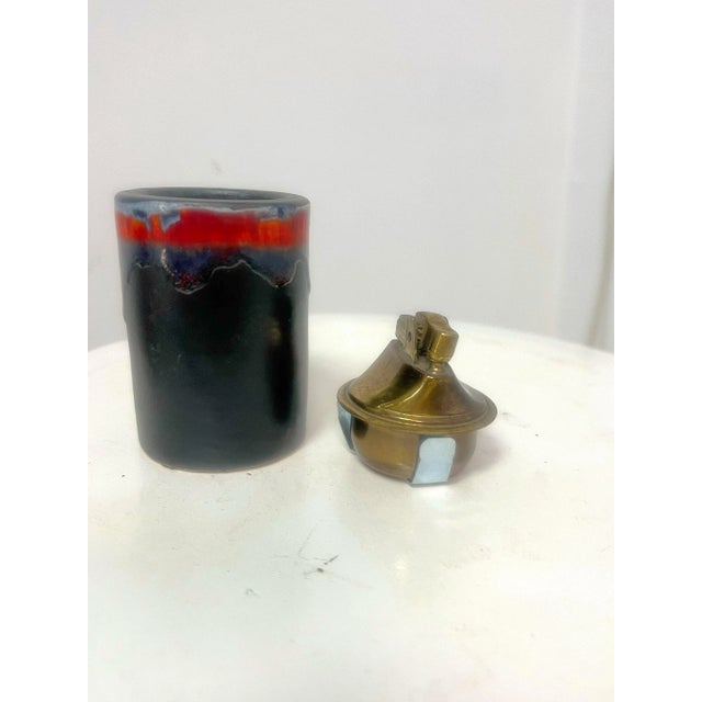 A fantastic lava drip glaze table lighter circa 1960’s. In red, light blue, dark blue. Signed on the bottom. Welcome to...