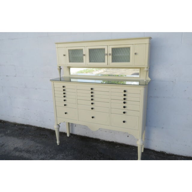 This magnificent Dental Cabinet is made of wood, solid wood, and glass. This gorgeous cabinet was made in the early 1900's...