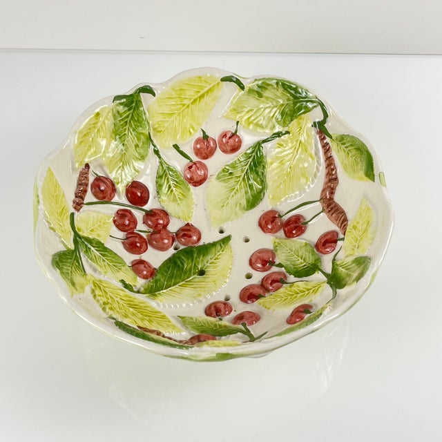 Cherry-patterned majolica fruit strainer, 1980/90 Dimensions: Diameter: 24 cm Height: 9 cm Very good overall condition,...