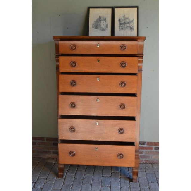 19th-century Dutch oak Empire wood chiffonier, chest of drawers. The height is 161 cm. The width is 95 cm. The depth is 46...