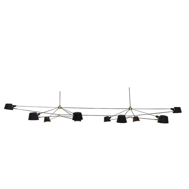 The Ravenhill Studio Double Pivot Chandelier is a striking, architectural fixture that combines modern engineering with...