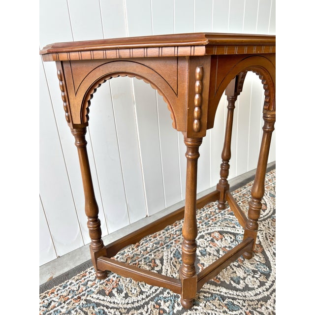Add timeless character to your home with this beautifully crafted vintage wooden accent table featuring elegant Gothic-...