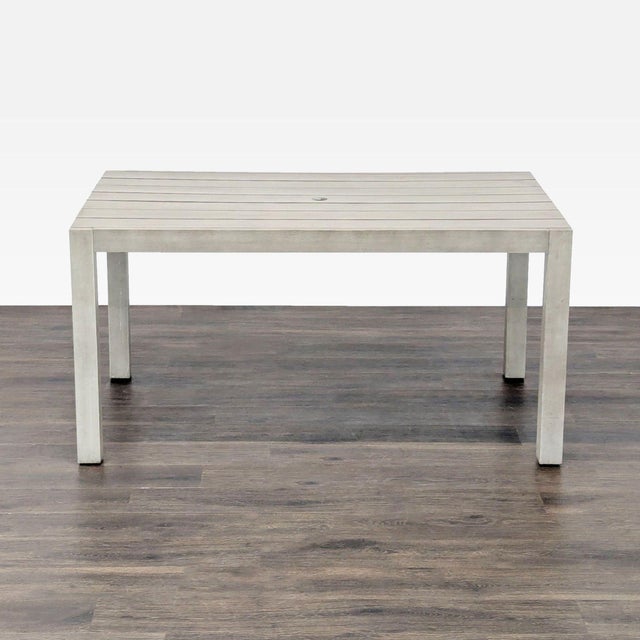 This CB2 dining table features a sleek, modern design with a light grey finish and slatted top. Made for both indoor and...
