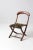 This late 19th century Victorian child's folding chair features a warm walnut frame, gently curved crest rail, turned...