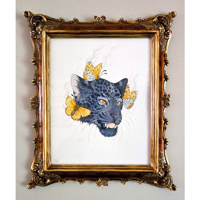 Amur Rarities features a striking portrayal of a black leopard's head, adorned with delicate butterflies and wisps of...