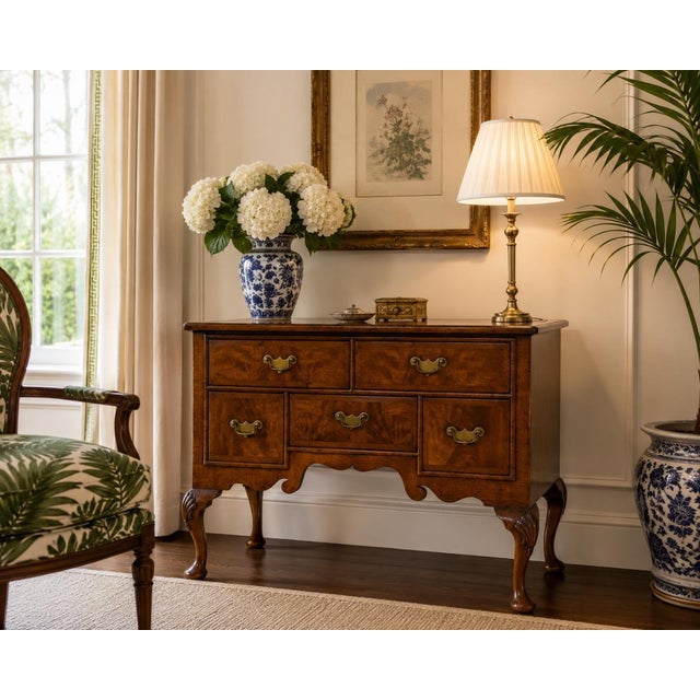 A beautifully crafted vintage English Queen Anne style dressing table featuring a warm walnut finish with striking book-...