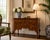 A beautifully crafted vintage English Queen Anne style dressing table featuring a warm walnut finish with striking book-...