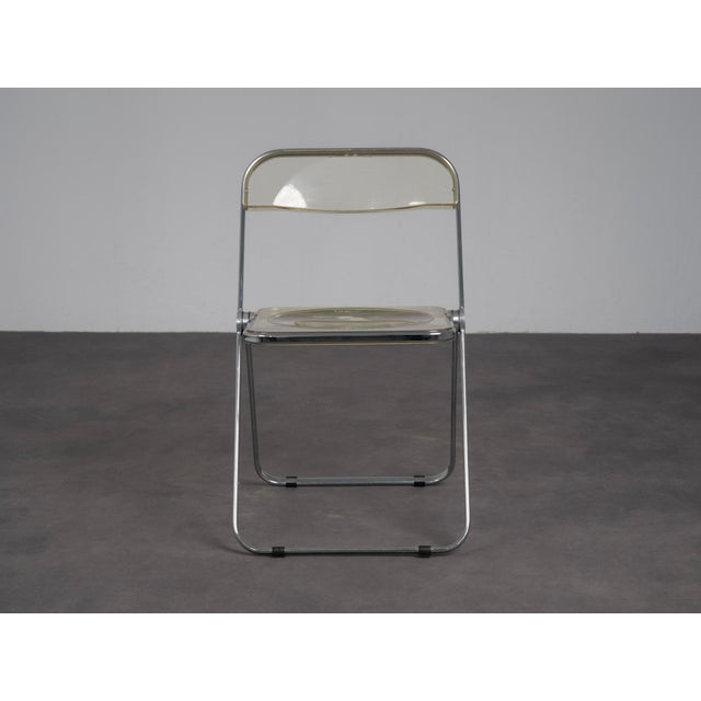 A pair of iconic plia folding chairs designed by giancarlo piretti for anonima castelli in the 1970s. Celebrated for their...