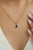 This solitaire pendant showcases a 0.7 carat natural pear-cut blue sapphire, set in 14K yellow gold. The sapphire...