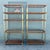 A striking pair of vintage Palm Beach Chic étagères featuring warm rattan frames accented with slender fluted gold-tone...