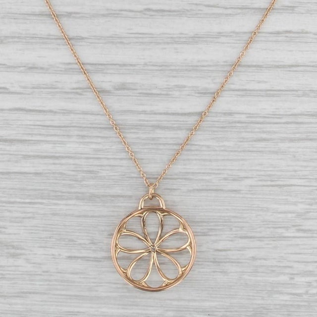 This lovely Tiffany & Co necklace is titled Garden Flower and featues fine cable chain from which a pendant of a delicate...