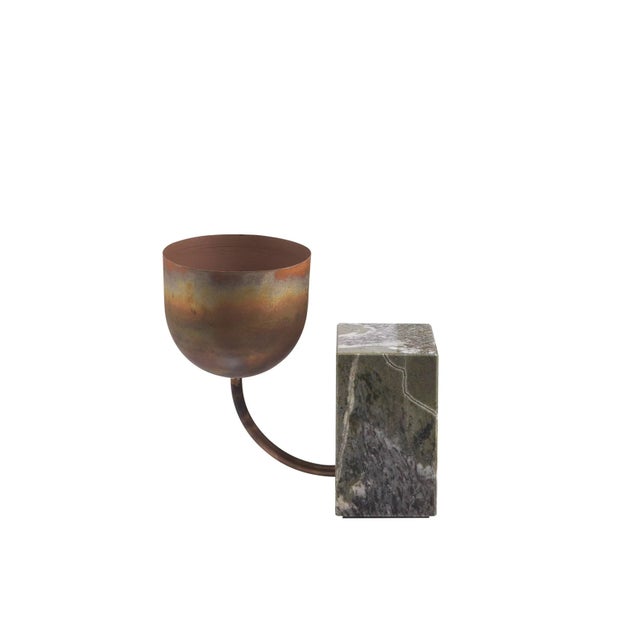 The stone, with its primordial strength and its material beauty, becomes a powerful base from which metal extensions grow...