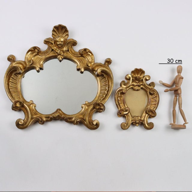 Triptych of carved and gilded wooden frames consisting of a mirror and a pair of photo frames. This piece is attributed to...