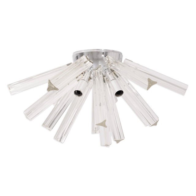 This striking Mid Century Modernist ceiling light features an array of hand-blown Murano glass rods radiating from a...