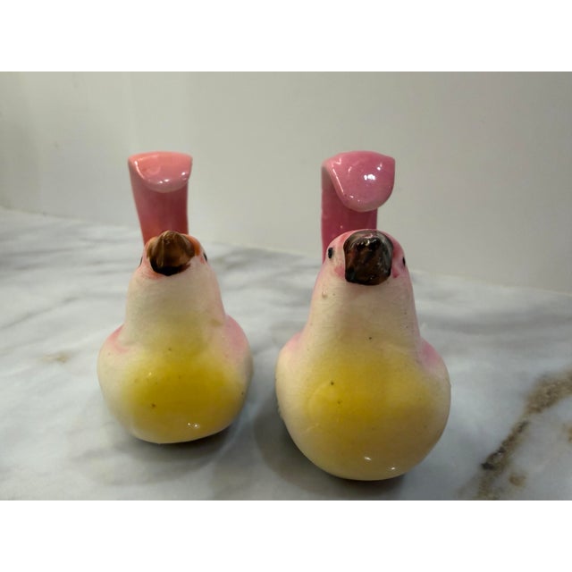 A cheerful pair of vintage figural salt and pepper shakers from 1950s Japan, modeled as plump little songbirds with...