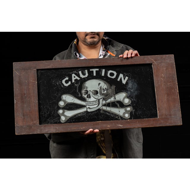 Striking ROG Odd Fellows lodge sign featuring the word “CAUTION” arched above a skull-and-crossbones motif. Executed in...