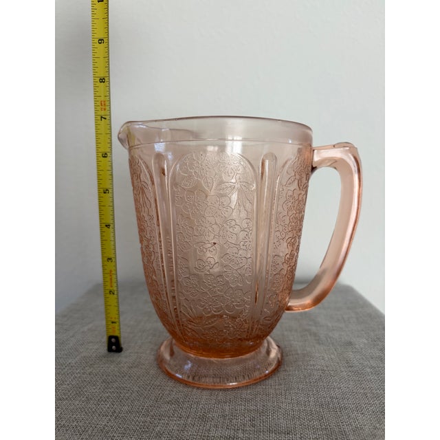 Vintage Jeannette Cherry Blossom Pink Depression Glass pitcher, standing at 7 inches tall and holding 36 ounces. With a...