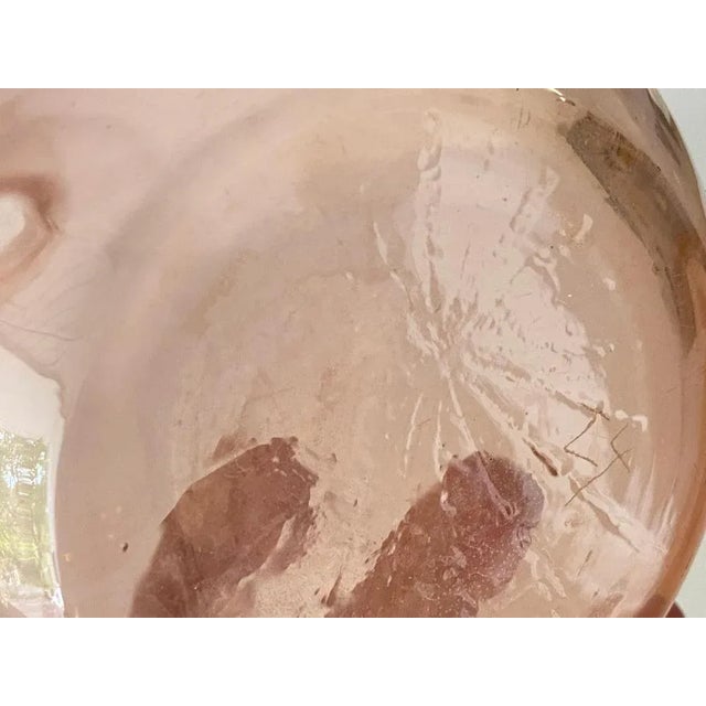 This glass decorative bottle, has been made in France, circa 1940. It is a typical Art Deco Style shape, in a pink color...