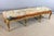 Large Louis XV-style giltwood bench resting on eight legs. This seat is covered with a rug in very good condition. 20th...