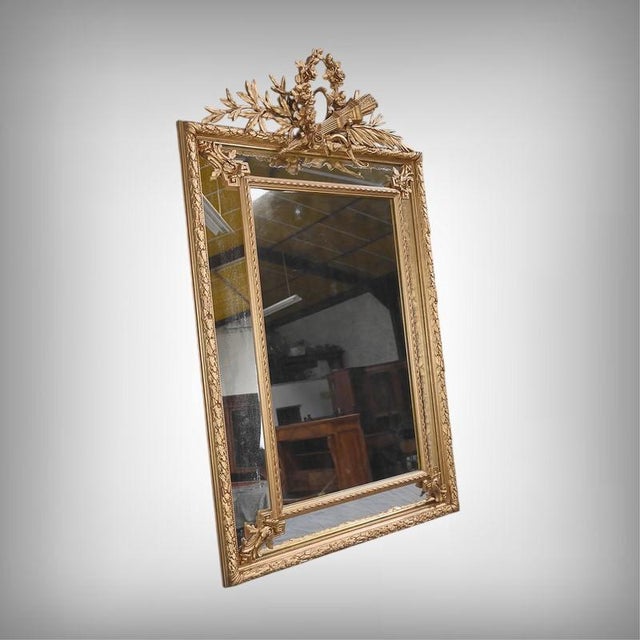 This large Louis XVI style mirror with its framed panels exudes a serene and perfectly controlled elegance. Its tall,...