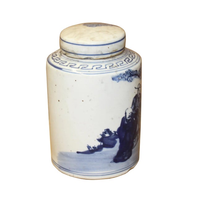 This is a handmade ceramic container urn jar in the off white base color. The surface has a blue color Fok Lok Shou...