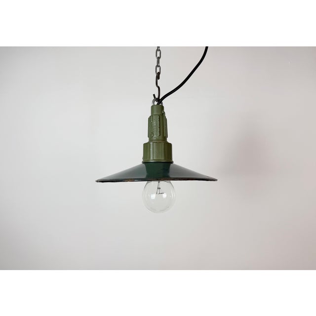 Industrial petrol enamel pendant light made in Poland during the 1960s. White enamel inside the shade. Green cast...