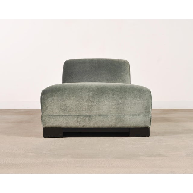 A stylish low-slung chaise loungue or daybed upholstered in an elegant sage green mohair fabric. The fabric is plush and...