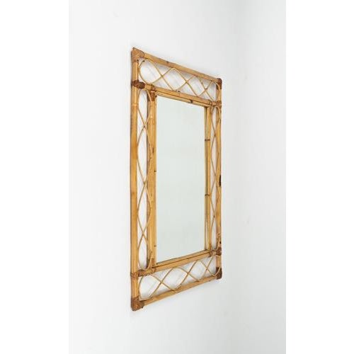 Mid-century wonderful wall mirror in curved rattan and bamboo. Made in Italy in the 1960s. The frame features a refined...