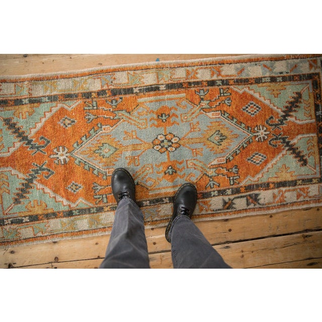 :: Elongated shieled-like center medallion atop a partially covered field of minor blossoms and diamond shaped checkered...