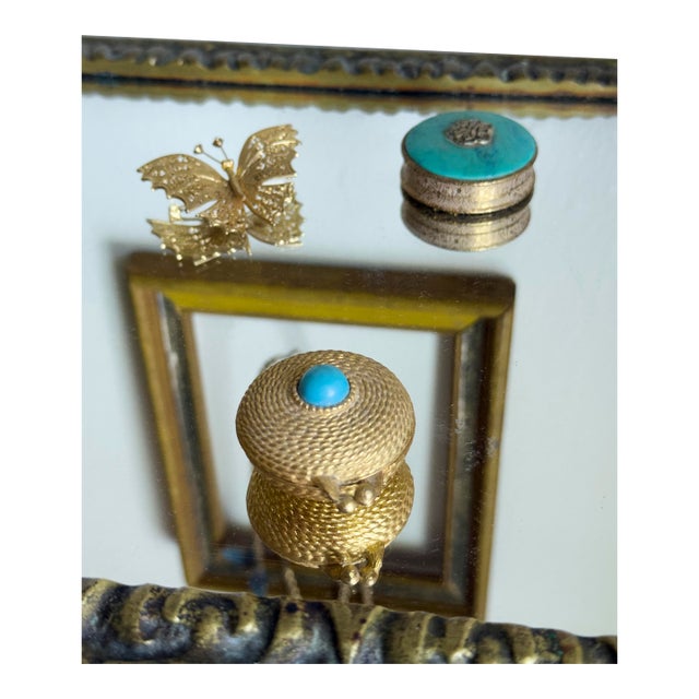 Vintage 1960s Estée Lauder gold-tone compact with coiled rope motif detailing and simulated turquoise resin accents. Kiss-...