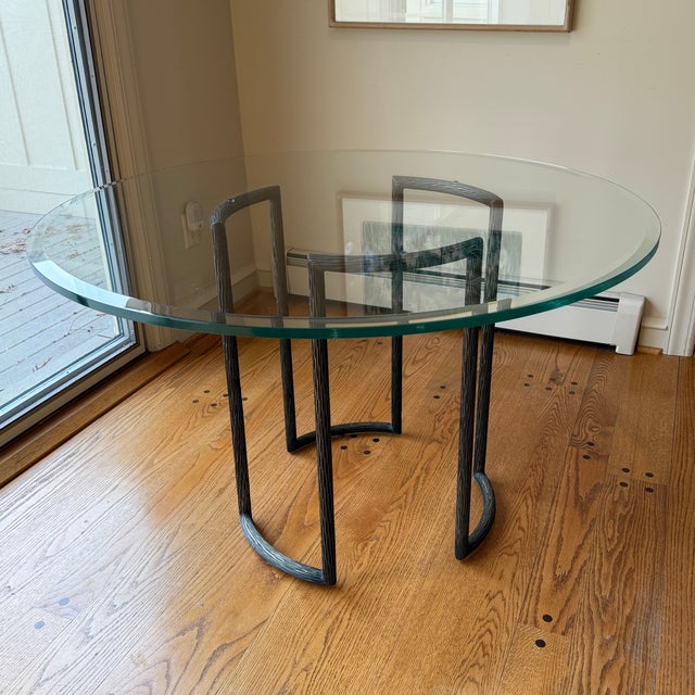 McGuire Furniture Company textured bronze and glass round dining table from the Thomas Pheasant outdoor collection. The...