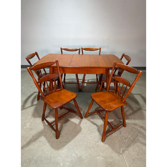 Vintage Cushman style 1950’s solid maple wood dining set. Extension table with one leaf, and matching hidden self stowing...