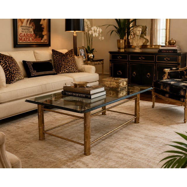 A striking 1970s Mastercraft faux-bamboo coffee table that delivers classic Hollywood Regency style with warmth, elegance,...