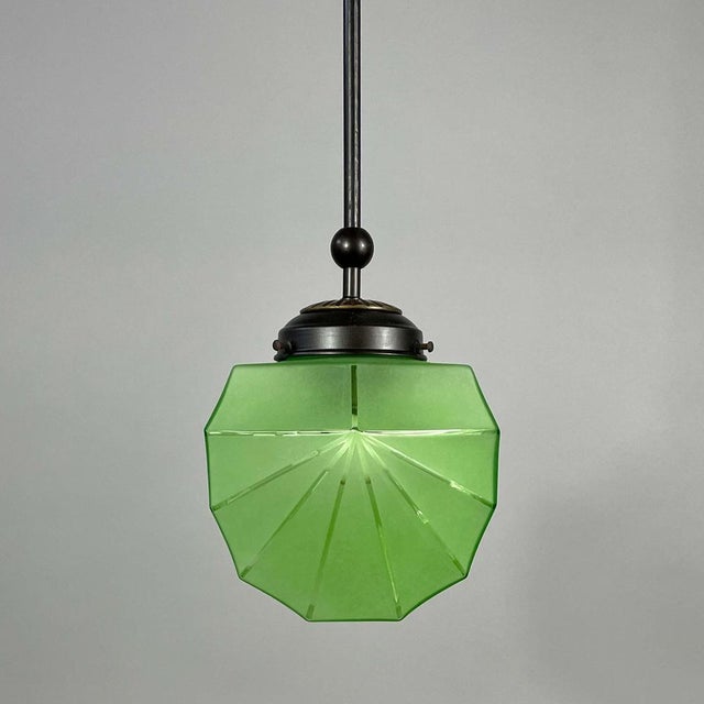 This elegant pendant was designed and manufactured in sweden in the 1920s to 1930s. The light features a faceted uranium...