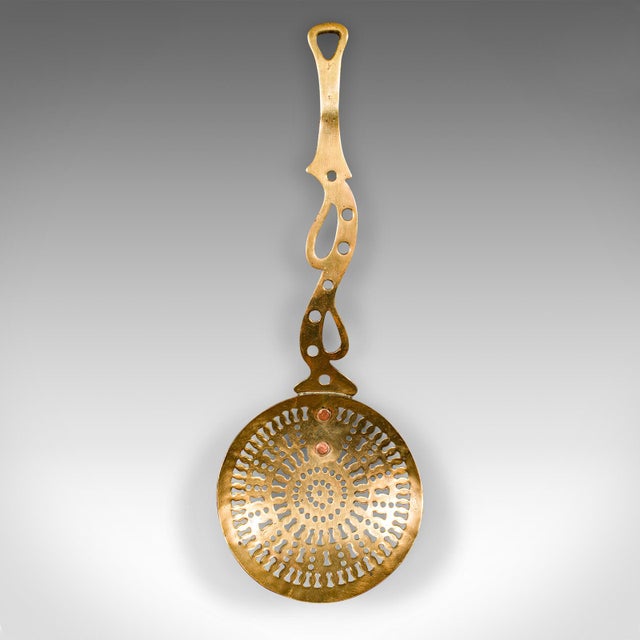 This is an antique fireside warmer. An English, pierced brass fireplace accessory, dating to the Georgian period, circa...