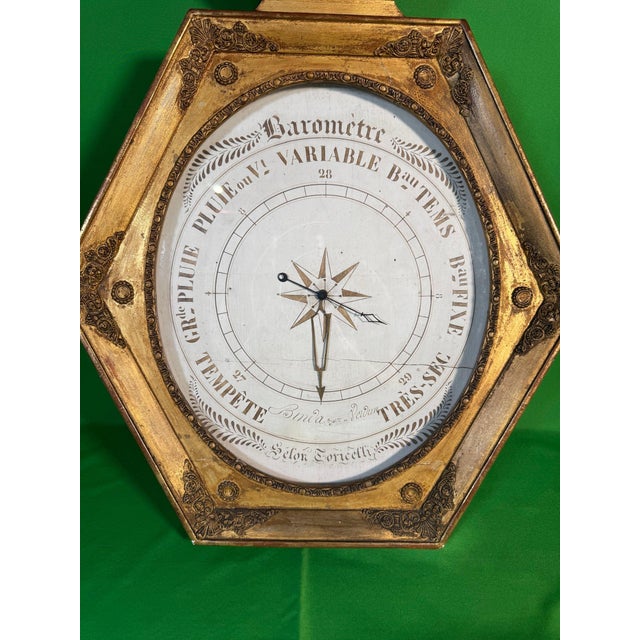 A French Restauration (Charles X period) weather instrument, circa 1820-1840, in the classic lyre-form case: carved and...