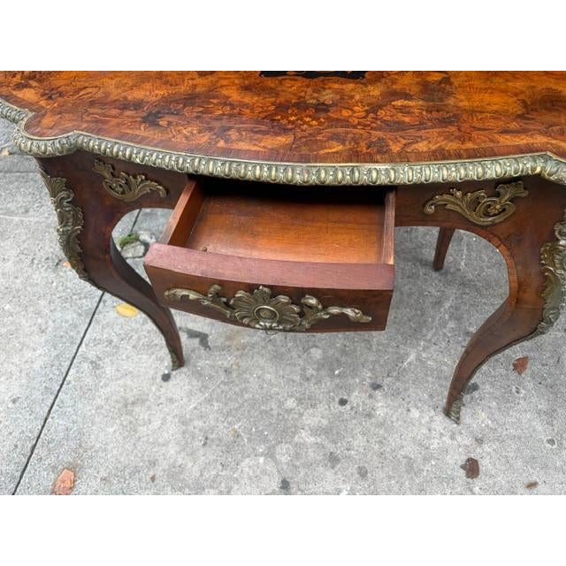 This antique French walnut and marquetry ladies writing desk from the 19th century exudes elegance and sophistication....