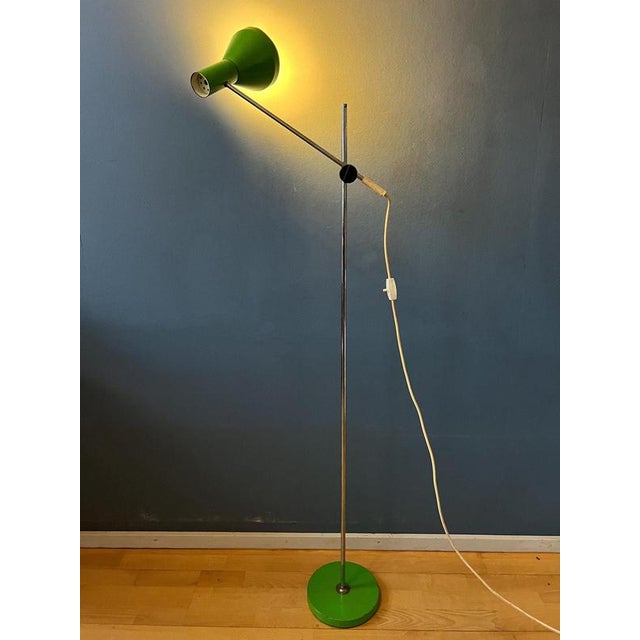 Apple green mid century floor lamp with adjustable arm. The design allows you to position the arm at a different height...
