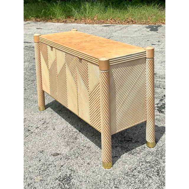 Infuse your space with the captivating charm and textural richness of this Vintage Boho Chevron Rattan Credenza. A...