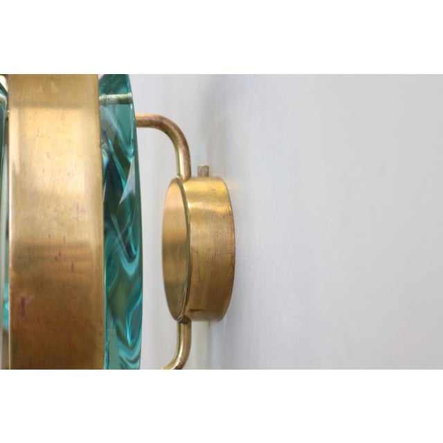 A rare pair of elegant "Micro" wall lights, model 2240, by Max Ingrand for Fontana Arte, featuring double-lens panels of...