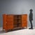 Vintage furniture of Italian manufacture of the 20th century with swing doors and central display cabinet with shelves....