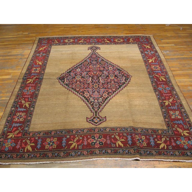 The open straw-camel field pulls back to reversal a dark blue pendanted entre with a close allover Herati design accented...