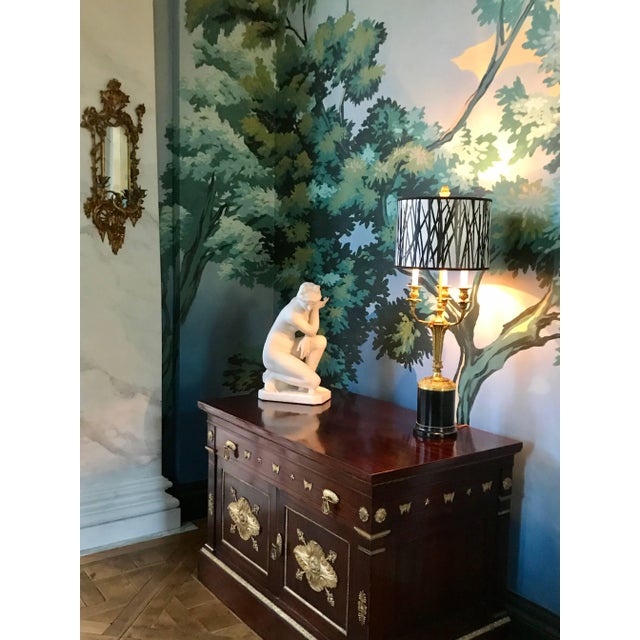 A wonderful pair of Rococo chinoiserie giltwood two-arm wall sconces is carved in the manner of Linnell. In a whimsical...