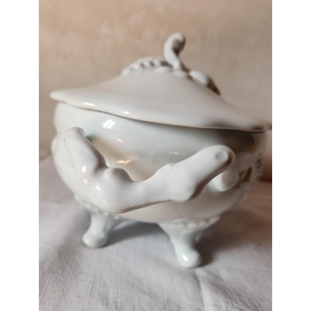This is a lovely French Deshoulieres tureen made of porcelain with grape vine handles and fruit decoration yet with a...