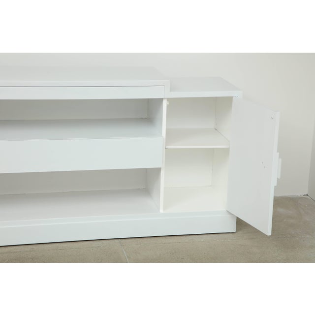 Stunning Minimalist cabinet by James Mont. The cabinet has been newly refinished in a high gloss white lacquer. The...