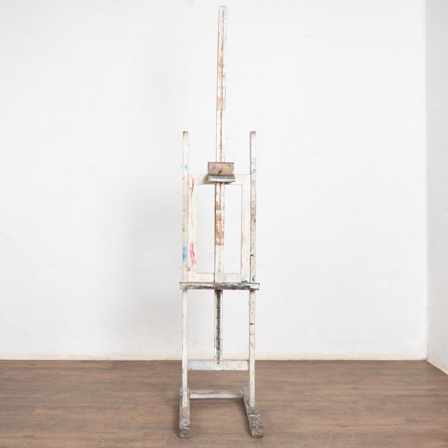 Late 19th Century White Antique Wood Painter's Easel This vintage white painted artist's easel reveals years of use as...