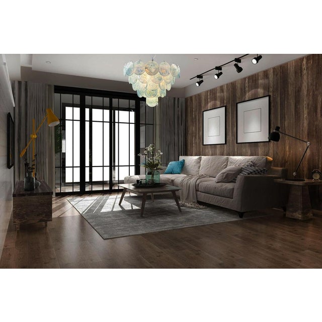 Italian murano chandelier. The chandelier has 57 murano blue albaster iridescent glass disks. The glasses are now...