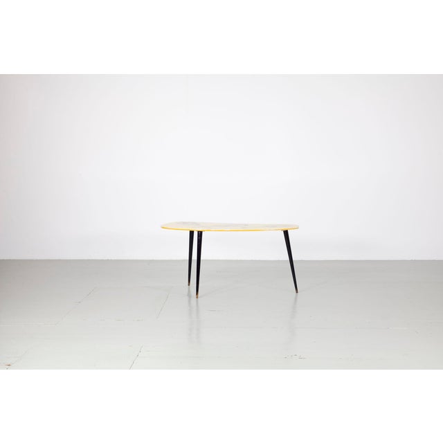 Authentic 1950s-style side table with a charming guitar motif—presumably a design by Aldo Tura. The table legs are...